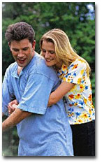 Couple watering flowers
